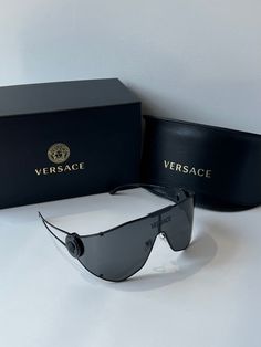 Brand new Versace VE2268 143387 Black Medusa Shield Sunglasses. Oversized shield with medusa detailing on temples and metal logo across center of lens. 1-14-115mm measurements. Black lens. Comes with box, case, cloth, and all papers. Luxury Matte Black Shield Sunglasses With Uv Protection, Luxury Matte Black Shield Sunglasses With Uva Protection, Luxury Matte Black Shield Sunglasses With Anti-reflective Coating, Luxury Matte Black Anti-reflective Shield Sunglasses, Luxury Rimless Shield Sunglasses With Uva Protection, Luxury Matte Black Shield Sunglasses With Mirrored Lenses, Medusa Shield, Black Medusa, Sunglasses Oversized