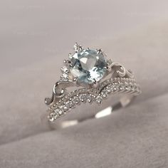 * The delicate ring displays aquamarine as main stone. The curved band beneath the gemstone makes the ring like an elegant crown.  For who wearing this dainty ring, will shine like a queen.  ◆ Production Description: Main stone Type: Aquamarine Main Stone Shape: Round Cut Main Stone Size: 7*7mm Side stone: CZ Metal: 925 Sterling silver - Other options available in the drop down menu ◆ Customization: √Free for Add Engraving  √Other Metal Type Available √Other Gemstones & Shapes Available  √Person Eternity Band Engagement Ring, Elegant Crown, Cute Promise Rings, Cute Engagement Rings, Future Engagement Rings, Zierlicher Ring, Dream Engagement Rings, Half Eternity Band, Aquamarine Ring