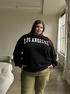 Introducing the Plus Size Los Angeles Crewneck Sweatshirt - a stylish addition to any wardrobe. This sweatshirt offers fashion-forward trends, allowing you to look fun and trendy in a preppy way. Plus, this is one of the softest sweatshirts we have ever stocked. This sweatshirt features a crewneck neckline, long sleeves, a comfortable oversized fit, and words across the chest. The material is an incredibly soft, cozy woven. This pullover sweatshirt is made out of 60% Cotton and 40% Polyester. Im Trendy French Terry Tops With Ribbed Cuffs, French Terry Tops With Graphic Print For Loungewear, Graphic Print French Terry Tops For Loungewear, Trendy French Terry Crew Neck Tops, Trendy Crew Neck Sweater, Casual French Terry Long Sleeve Tops, French Terry Long Sleeve Tops For Spring, Spring Varsity Long Sleeve Tops, Casual Black French Terry Top