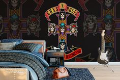 a bedroom with skulls and guitars on the wall, along with a cross painted on the wall