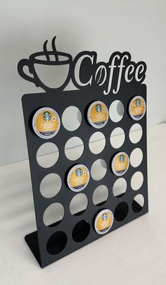 a coffee cup holder with six cups on it and the word coffee written in black