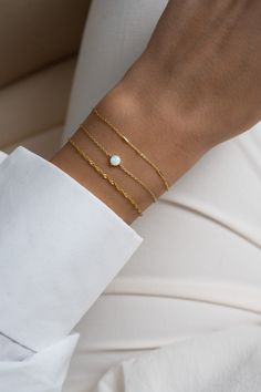 "This solitaire opal bracelet is a sweet and dainty addition to your jewelry collection! It's minimalist design makes it great for stacking, but also looks great on its own! -  -  - D E T A I L S - - - * Made of 925 Sterling Silver * THICK plating of 14k Gold or Rhodium  * 6.25\", 6.75\" , or 7\" + .5\" Ext Lengths available  * Lan created opal stone is made of highest grade of quality for an authentic look! * Nickel-free & Hypoallergenic  * 5mm Opal Stone Bracelets on Model: Turquoise Tennis Bracelet: https://www.etsy.com/listing/1050935357/turquoise-bracelet-turquoise-tennis?click_key=a1a1e3ea13ccfb6cdba3a13472c1aa26c481fdb5%3A1050935357&click_sum=f47583dc&ref=shop_home_feat_2&pro=1 Opal Bracelet: https://www.etsy.com/listing/1063792532/opal-bracelet-white-opal-bracelet?click_key=bc44a7a Minimalist Opal Jewelry With Delicate Chain, Minimalist Everyday Opal Jewelry, Elegant Adjustable Opal Beaded Bracelets, Minimalist White Bracelet With Delicate Chain, Dainty Adjustable Opal Bracelet, Elegant Opal Beaded Bracelets As Gift, White Dainty Bracelet With Delicate Chain, Sage Christmas, White Opal Bracelet