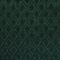 a close up view of a green fabric textured with diamond shapes and diagonals