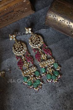 Experience the epitome of traditional elegance with our exquisite earrings, expertly encrusted with intricate Kundan details and showcasing a stunning floral design at the top. The attached peacock motifs add a touch of majestic charm, while the dangling mint Fluorite stones and trinkets of pearls create a mesmerizing display of luxury. These traditional masterpieces embody the perfect blend of classic sophistication and whimsical flair, making them ideal for special occasions or everyday opulence. Closure - Push Back  Weight - 55gm (pair) Handcrafted in Jammu and Kashmir Elegant Peacock Design Chandelier Earrings For Festive Occasions, Elegant Chandbalis With Peacock Design For Diwali, Festive Fusion Bridal Earrings With Meenakari, Elegant Festive Chandelier Earrings With Peacock Design, Fusion Kundan Chandelier Earrings With Latkans, Fusion Style Kundan Chandelier Earrings With Latkans, Fusion Kundan Bridal Earrings With Cutdana, Ceremonial Chandbali Earrings With Stone Work, Fusion Bridal Earrings With Kundan And Cutdana