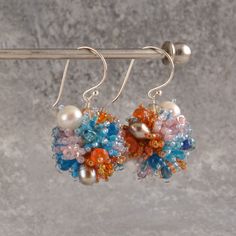 Lovely ball earrings with color power. Seed beads from Japan, freshwater pearls, a lot of different beads. Earrings are 4 cm long and the ball is 2,2 cm. Silver or gold plated hooks.  FAST SHIPPING   Need this item fast? We offer a Faster Shipping option here: https://www.etsy.com/shop/smykkeunivers/?etsrc=sdt&section_id=41039562 Europe 2-4 business days USA, Canada and rest of the world 4-7 business days Any questions, just ask. Multicolor Drop Pearl Earrings For Wedding, Unique Beaded Wedding Earrings, Multicolor Beaded Earrings For Wedding, Handmade Dangle Cluster Earrings For Anniversary, Handmade Fusion Style Bridal Drop Earrings, Handmade Multicolor Earrings For Anniversary, Multicolor Crystal Earrings For Wedding, Handmade Multicolor Drop Bridal Earrings, Multicolor Handmade Drop Bridal Earrings