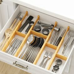 an organized drawer with silverware and utensils