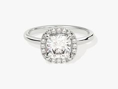 a cushion cut diamond ring with halos around it