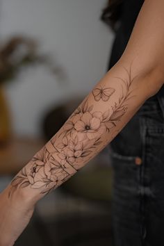 a woman with a flower tattoo on her arm