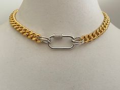 9mm wide, this is a substantial gold plated Miami Cuban chain necklace with great weight. It's joined with a silver rhodium plated, Cubic Zirconia carabiner clasp and silver links. Mixed metal has become a very trendy fashion and adds to the uniqueness of this piece. Makes the perfect gift for yourself or someone special. The necklace look great on its own or layered. This listing is for the Cuban chain only. Please see other listings for layering. Also available in Silver. Tips to keep your jew Silver Chain Necklace With Oval Link And Gold Chain, Gold Cuban Link Necklace With Silver Chain, Silver Tips, Cuban Chain Necklace, Mixed Metal Jewelry, Miami Cuban, Cuban Chain, Keep Jewelry, Mixed Metals