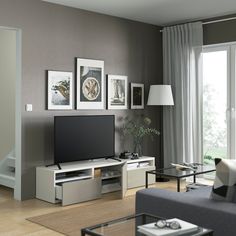 a living room filled with furniture and a flat screen tv on top of a stand