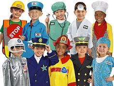 a group of children dressed up in uniforms and hats posing for a photo with each other