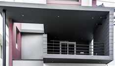 an apartment building with balcony and balconies on the second floor is painted pink and white