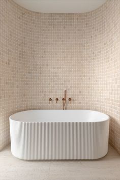 A bathroom features brushed copper tapware, a large bath and a curved feature wall with travertine tiles. Teenager Bathroom, Bathroom Accents, Wall Tiles Design