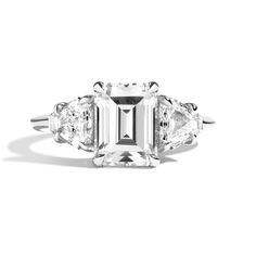 an emerald cut diamond ring with three side stones