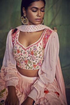 This hand-painted georgette crepe lehenga is paired with an intricate multi-hued embroidered blouse with a fun-loving blouson sleeves pattern.  The outfit is completed with a semi pleated detailed dupatta. Multicolor Georgette Blouse For Reception, Multicolor Georgette Blouse With Sheer Dupatta, Festive Pink Georgette Top, Pink Long Sleeve Choli With Mirror Work, Multicolor Georgette Blouse With Mirror Work, Designer Pink Georgette Blouse, Pink Georgette Blouse With Sheer Dupatta, Pink Georgette Blouse With Dupatta, Pink Georgette Pre-draped Saree With Floral Embroidery