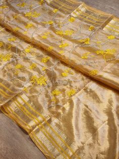 Metalic tissue sarees with embroidery and kathan border  Prebooking Tussar Silk Pre-draped Saree For Diwali Celebration, Semi-stitched Gold Pre-draped Saree With Dupatta, Gold Embroidered Silk Pre-draped Saree, Gold Embroidered Art Silk Pre-draped Saree, Gold Raw Silk Pre-draped Saree For Festivals, Festive Pre-draped Tissue Silk Saree With Zari Work, Festive Gold Art Silk Pre-draped Saree, Gold Pre-draped Saree With Zari Weaving For Eid, Festive Gold Pre-draped Saree In Tissue Silk