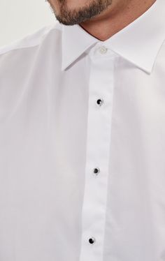 Pure Cotton Stud Button French Cuff Tuxedo Shirt is the most classical option, and the way to go for the minimalist taste. It is a tribute to the historical classical top three buttons tuxedo shirt setup. The shirt stud is a piece of jewelry that is essentially used in place of buttons and they come with the shirt. These studs can be replaced with our precious metals and crystals studs if desired. The metal studs are usually required in formal events, they are passed through two buttonholes, one Formal White Buttoned Top, Formal White Tops With Buttons, White Buttoned Top For Formal Occasions, Classic White Tops With Covered Buttons, Formal White Tops With Covered Buttons, White Formal Tops With Covered Buttons, Classic Formal Tops With Covered Buttons, Elegant Tailored Shirt With Buttons, Elegant White Shirt With Button Closure