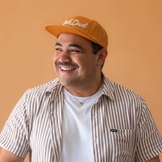 Treat your rad dad to the ultimate accessory - our burnt orange flat brim hat! With high quality ivory embroidery and a stylish design, it's perfect for on-the-go errands and everyday dad life. Don't miss out on this cool, must-have hat for the coolest dad around. Casual Brown Flat Cap Trucker Hat, Casual Brown Baseball Cap, Casual Brown Fitted Hat, Casual Orange Baseball Cap With Curved Brim, Casual Orange 5-panel Trucker Hat, Orange 5-panel Casual Hat, Casual Orange 5-panel Hat, Casual Orange Cap, Orange Curved Brim Snapback Hat