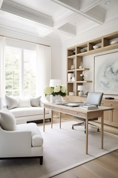 a living room filled with furniture and a large painting on the wall above a desk