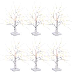 six small white trees with yellow lights on them, each set in four different sizes