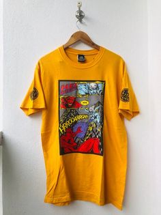 PLEASE ASK ANY QUESTION BEFORE BUYING!!! THIS IS USED CLOTHING!!! PLEASE DONT EXPECTED IT TO BE LIKE NEW OR IN PRISTINE CONDITION!!!PLEASE REFER TO THE ACTUAL/MANUAL SIZE TAKEN!!!Size on tag : MCondition : 8/10Made : USA assembly HondurasColor : Yellow / Brand Logo / ArtMeasurement :armpit to armpit= 20"inchesLenght from top of the shoulder to bottom= 30"InchesIn a good vintage condition Vintage but still good and niceNo tears No Stains and GoodSHIPPING (Your Choice Please read)1. The shipping c Graphic Cotton T-shirt For Skateboarding, Unisex Pop Culture T-shirt For Streetwear, Pop Culture Sublimation Print Top For Streetwear, Yellow Graphic T-shirt For Streetwear, Yellow Graphic Tee With Graffiti Print, Band Merch Graphic T-shirt For Skateboarding, Pop Culture Graffiti Print Top For Streetwear, Yellow Pop Culture T-shirt With Character Print, Yellow Pop Culture Character Print T-shirt