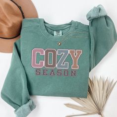 Fall Sweatshirt, Cozy Season Fall Sweatshirt, Cozy Season Merry Christmas, Christmas Sweatshirt, Winter Sweatshirt, Stay Home, Cozy Vibes Embrace the cozy vibes of fall and winter with our "Cozy Season" sweatshirt! Perfect for snuggling up at home, sipping hot cocoa, or celebrating the holidays in style. This soft and warm sweatshirt is your ultimate companion for chilly days and nights.  Luxurious comfort and style are what this unisex, garment-dyed sweatshirt is all about. It's made with 80% r Cozy Holiday Sweatshirt For Fall, Cozy Sweatshirt For Holiday And Fall, Cozy Sweatshirt For Fall Holiday, Cozy Fall Holiday Sweatshirt, Cozy Christmas Sweatshirt With Relaxed Fit, Cozy Relaxed Fit Christmas Sweatshirt, Green Cozy Sweatshirt, Green Cozy Fit Sweatshirt, Cozy Winter T-shirt With Relaxed Fit