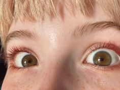 a close up of a child's eyes with freckles