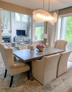 the dining room table is surrounded by beige chairs