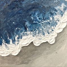 an aerial view of the ocean waves and sand