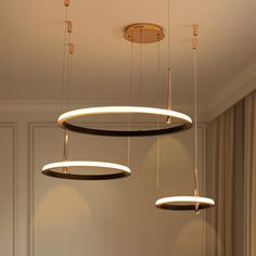 three circular lights hanging from the ceiling in a room