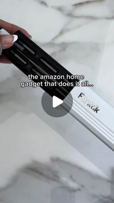 a person holding an electronic device in their hand with the words, the amazon home gadget that does it all