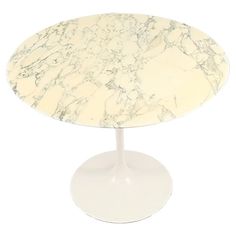 a white marbled table with an oval base and round top, on a white background