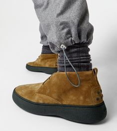 Characterized by a chunky but at the same time sober and refined outsole, the Tod's W. G. style is here proposed in desert boot version. Crafted in suede, with iconic rubber pebbles on the bottom and heel, they are enhanced by Tod's monogram stamped on the front. Casual Desert Boots With Vibram Sole For Walking, Casual High-top Calf Leather Boots, Casual Calf Leather Boots With Vibram Sole, Ankle-high Boots With Contrast Sole For Walking, Casual Low-top Calf Leather Boots, Casual Calf Leather Boots With Contrast Sole, Casual Calf Leather Boots With Textured Sole, Casual High-top Lace-up Calf Leather Boots, Casual High-top Lace-up Boots In Calf Leather