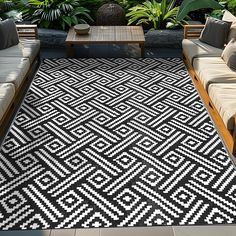 a black and white area rug in the middle of a patio