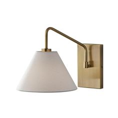 a wall light with a white shade on the arm and a gold metal frame,