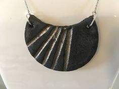 "This minimalist black clay pendant with interesting shape was glazed with special porcelain glaze  and firing at 1250 degrees Celsius. In the next stage decorated with platinum. For MEN and WOMEN - it is simple but oryginal jewellery for every occasion and everyday use absolutely. The pendant is 100% handmade - even modeled. Truly unique piece of jewelry - there are never two pieces that look the same.  Dimensions: Length 3.5cm x Width 4.5 cm x thickness 0.5 cm (in inches: 1.38\"x 1.77\" x 0.20\") Length of chain: 40 cm ( 15.75\" )   Silver snake chain (silver 925)  The chain include an extension (silver plated chain) to 5 cm more  ( 1.97\" ).  Elegant jewelry box (shown on photo) in set. Colors as in pictures (may vary slightly due to monitor settings). This porcelain necklace is the per Porcelain Necklace, Romantic Jewellery, Unique Gifts For Men, Black Clay, Silver Snake Chain, Jewelry Unique, Minimalist Necklace, Elegant Jewelry, Gift For Men