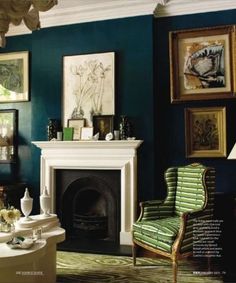 a living room filled with furniture and pictures on the wall above a fire place in front of a fireplace