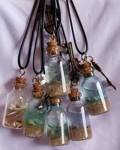 This ocean scenery bottle necklace features mini glass bottles with a blend of water, sand, seashells and resin, artfully arranged to create a breathtaking underwater seascape. The captivating design makes a unique statement piece, ideal for any beach or ocean-inspired outfit. Beach Sand Necklace, Mini Glass Bottle Necklace, Sand And Seashells In Jar, Sand Jars From Vacation, Ocean Outfit Ideas, Ocean Themed Accessories, Seashell Resin Art, Beach Sand Crafts, Underwater Seascape