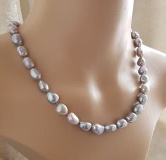 18" Grey baroque freshwater pearl necklace This beautiful grey baroque freshwater pearls approximately  9-10-8mm x 12-10mm very good lustre threaded on good quality natural silk thread, hand knotted between each pearl and a 925 sterling silver toggle clasp. The pearls are genuine freshwater pearls therefore each pearl is slightly different in shape and size and each pearls has it own unique natural blemishes.  All measurement mentioned in this listing is approximate The colour of the actual necklace might be slightly different to the photo due to the lighting More different colour and shape pearl necklaces listed https://etsy.me/3C8hp3e Please have a look at my other listing!  https://etsy.me/3vWV0SA Fresh Water Pearl Necklace, Water Pearl Necklace, Pearl Necklaces, Freshwater Pearl Necklace, Fresh Water Pearl, Wedding Jewellery Necklace, Natural Silk, Freshwater Pearl Necklaces, Silk Thread