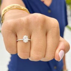 a close up of a person wearing a ring on their finger