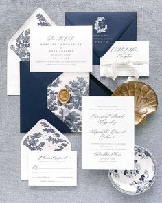 the wedding stationery was done in navy and white, with gold foil accents on the envelopes