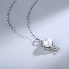 What's a better way to showcase your love for someone than with this charming piece? Set on a sterling silver ribbons, this pearl stands out and shines for all to see. Engrave your name or the name of a loved one to make it a unique gift.Chain Type: Weight: 2.1 gHeight: 30 mmMaterial: Plating Color: Silver Elegant Necklace With Pearl Charm As Gift For Her, Elegant Pearl Necklace As Gift For Her, Formal Pearl Necklaces For Mother's Day, Elegant Pearl Necklace For Her, Elegant Pearl Pendant Jewelry For Mother's Day, Elegant Pendant Pearl Necklace Gift, Elegant Sterling Silver Pearl Necklace With Clavicle Chain, Elegant Mother's Day Pearl Necklace With Clavicle Chain, Exquisite Pearl Necklace Gift With Elegant Design