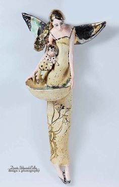 a ceramic figurine with an angel holding a baby in her arms on a white background