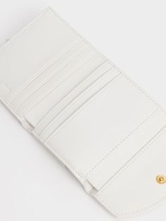 Embrace your feminine side down to your accessories with our Este belted small wallet. Featuring a luxurious panelled finish accentuated by a shiny gold-tone button, this piece is equal parts stylish and functional. Bonus points for the beautiful all-white hue that makes this wallet a timeless classic that will complement any outfit or bag. Spacious enough to hold all your cards, cash and mini essentials, carry this wallet as a clutch with your go-to little black dress and patent pumps. Mini Essentials, Small Wallet, All White, Timeless Classic, Little Black Dress, Black Dress, Pumps, Wallet, Gold