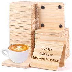 a stack of wooden coasters next to a cup of cappuccino coffee