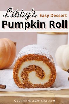 a pumpkin roll is cut in half and sitting on a table with other fall decorations