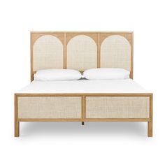 an image of a bed with white linens and wood headboard on the side