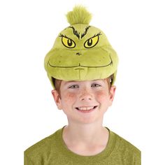 a young boy wearing a grin face hat