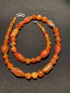 The orange color carnelian beads from my collections of ancient Himalayan antique beads The origin of this beads from Tibet Himalaya although the carnelian agate can be found in Nepal Pakistan India Nepal and Afghanistan as well carnelian agate was used as prayers beads in mala and used as jewelry and amulet as well old agate and carnelian was used as trade items as well in ancient times The age of this beads are more than 1000 years some gold color brass beads are used as spacers best gift for Traditional Orange Beaded Necklace With Gemstones, Traditional Orange Gemstone Beaded Necklace, Orange Round Beads Jewelry For Rituals, Traditional Orange Jewelry For Healing, Traditional Orange Healing Jewelry, Traditional Orange Gemstone Jewelry, Traditional Orange Gemstone Bead Necklaces, Traditional Orange Gemstone Beads Necklace, Traditional Orange Necklace With Natural Stones