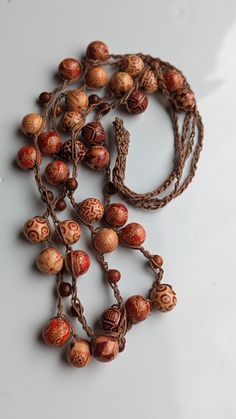 Embrace the spirit of bohemia with this exquisitely handcrafted crochet necklace, adorned with bold wooden beads that make a statement. Each bead is intricately designed, boasting unique patterns and rich, earthy tones that will add a touch of rustic elegance to any outfit. The comfortable crochet cord lays softly against your skin, making it perfect for all-day wear. Whether you're dressing up for a festival or accenting your daily attire, this boho necklace is versatile enough to be your go-to Crochet Cord, Beads Handmade, Boho Crochet, Egyptian Cotton, Rustic Elegance, Bohemian Jewelry, Jewelry For Women, Earthy Tones, Boho Necklace